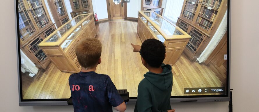 two school pupils using an interactive screen